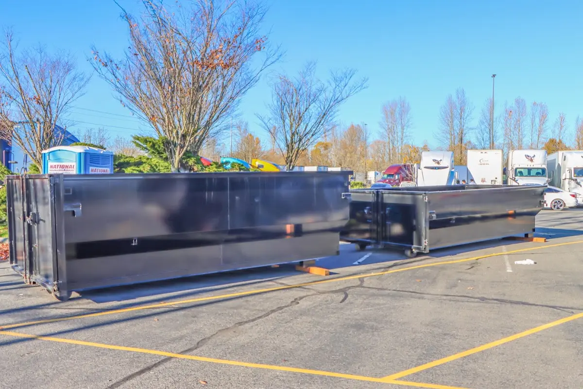 Professional dumpster rental service with roll-off container on residential driveway in Manassas